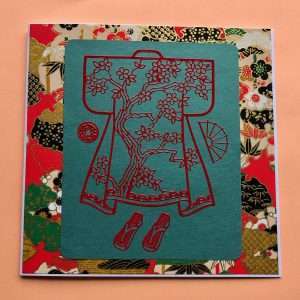 Imaeg of red kimono sticker on green washi paper