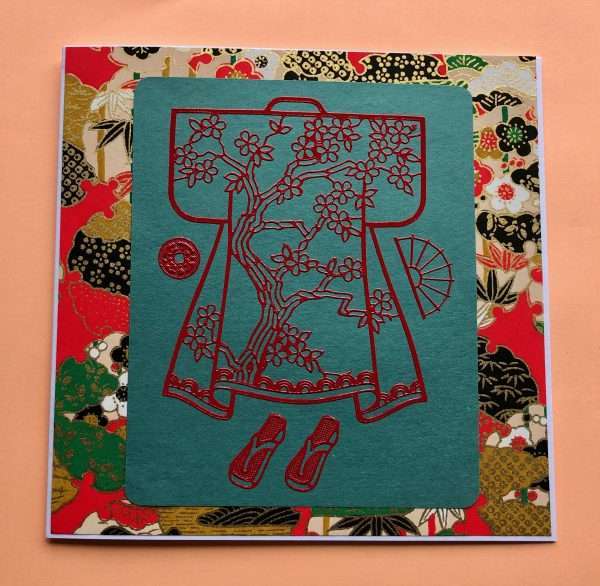 Imaeg of red kimono sticker on green washi paper