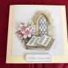 Church window with bible and flowers