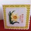 Image of cross stitched daffodil with Happy Birthday written vertically