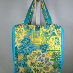 blue/green box shaped bag with a zip top