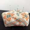 Image of biscornu pincushion with pins in