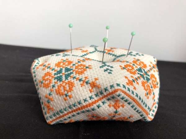 Image of biscornu pincushion with pins in