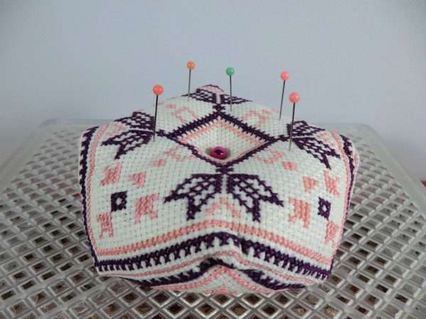 Biscornu pincushion showing pins on top
