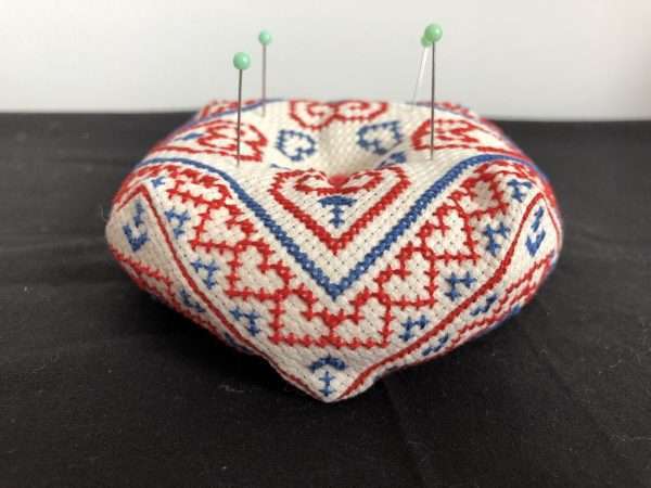 biscornu pincushion showing pins on top