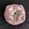 Biscornu pincushion in red and blue with heart shapes in pattern