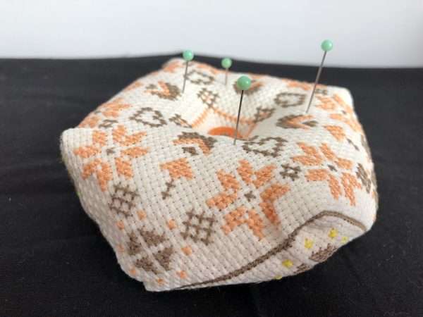 Biscornu pincushion orange/brown pattern with pins