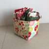 fabric storage box in shades of red with fat quarters in