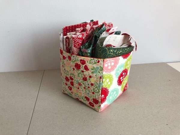 fabric storage box in shades of red with fat quarters in