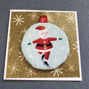 Card with skating Santa ornament