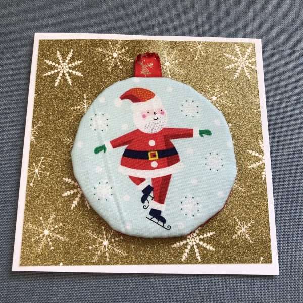 Card with skating Santa ornament