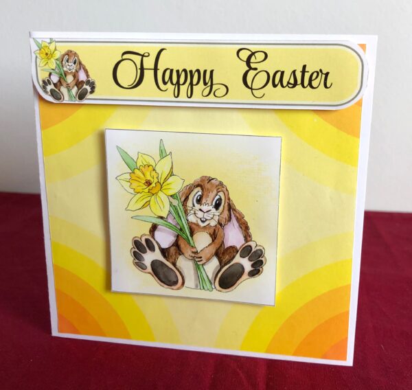 Easter card standing with an easter bunny holding a daffodil