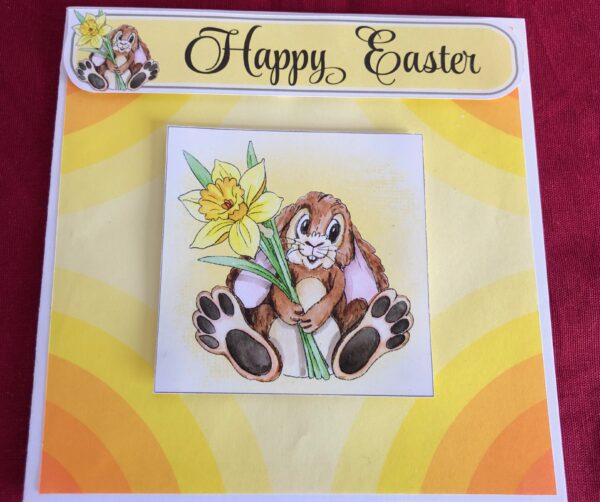 Decoupage card of Easter bunny with a daffodil in its hand