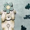 Decoupage birthday card closeup showing teddy holding a flower