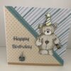 birthday card with bear holding champagne and glass