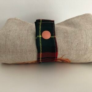 Folded bag with strap and press stud