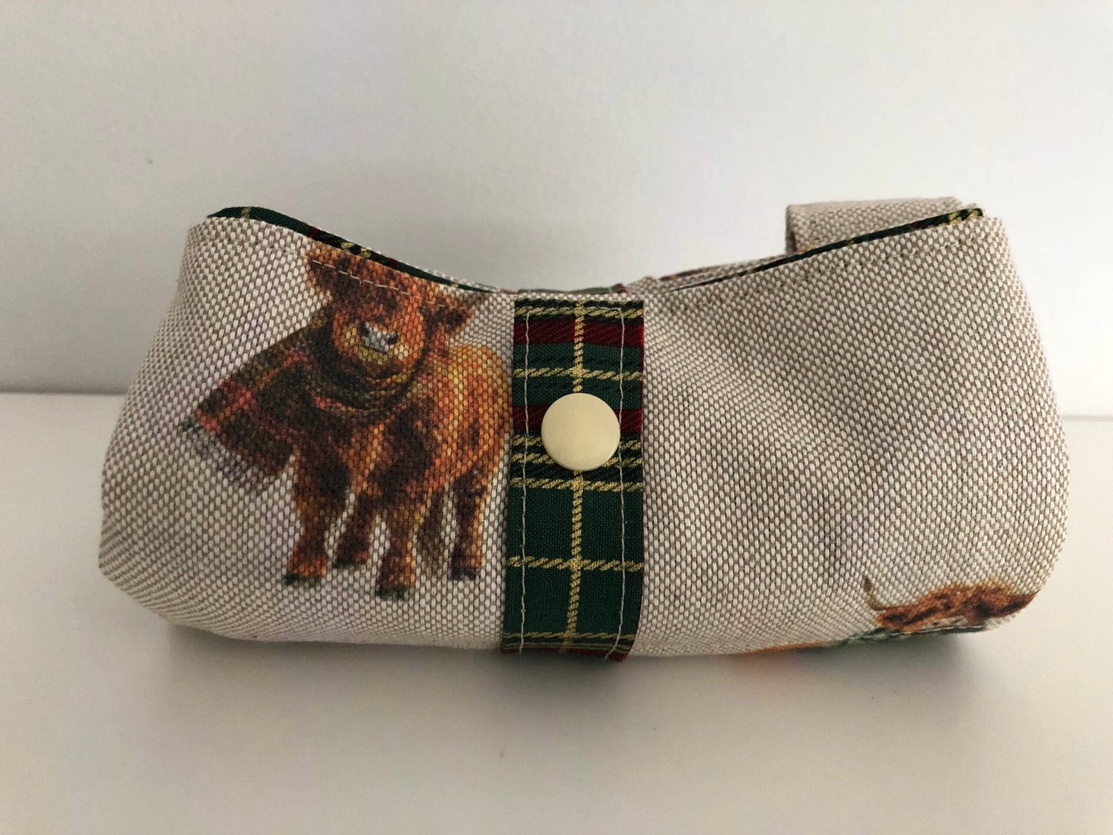 Folded bag with strap and press stud