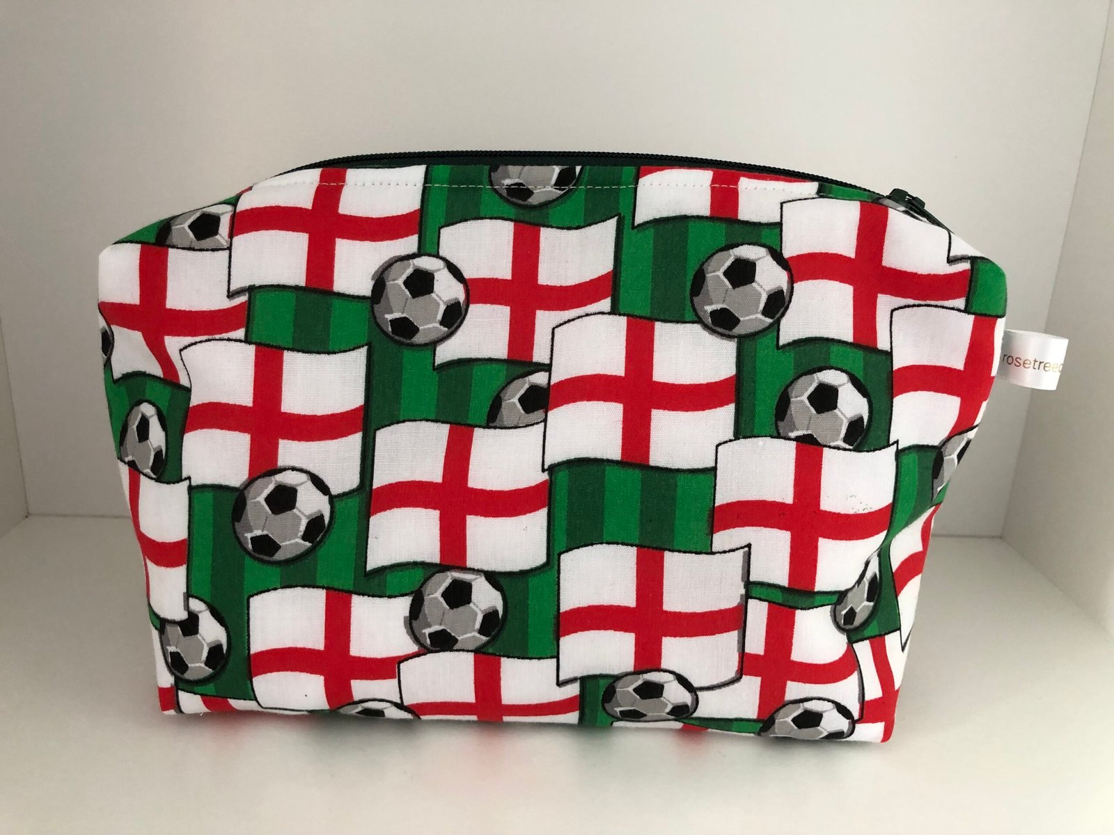 front of England football pouch with flags and footballs